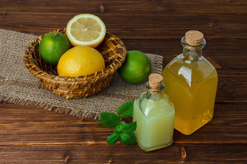 some lemon juice with half lemon piece sack basket wooden surface high angle view space text