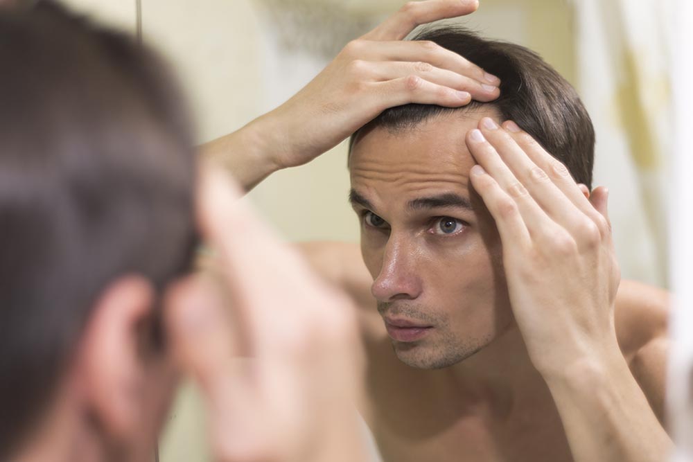 close up man grooming hair