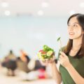 happy lady holding kitchen stuff copy space background